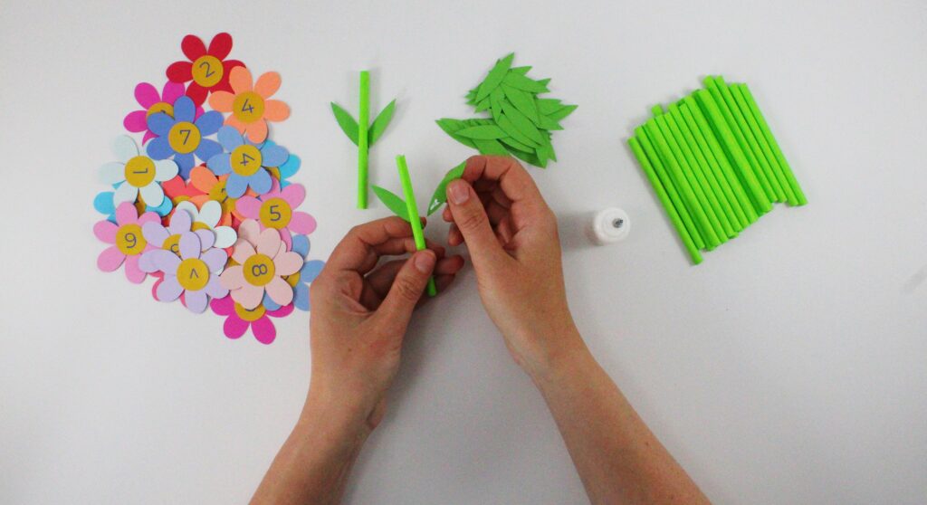 Gluing leaves onto straw stem